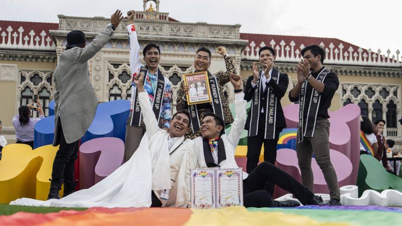 Members of the LGBTQ community celebrate after the Thai parliament passed the final senatorial vote on the same-sex marriage bill, at Government House in Bangkok on June 18, 2024. - Thailand on June 18 became the first country in Southeast Asia to legalise same-sex marriage, in a historic parliamentary vote hailed as a "victory" by campaigners. (Photo by Chanakarn Laosarakham / AFP) Members of the LGBTQ community celebrate after the Thai parliament passed the final senatorial vote on the same-sex marriage bill, at Government House in Bangkok on June 18, 2024. - Thailand on June 18 became the first country in Southeast Asia to legalise same-sex marriage, in a historic parliamentary vote hailed as a "victory" by campaigners. (Photo by Chanakarn Laosarakham / AFP)