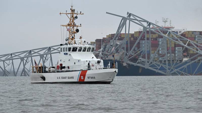 The US Coast Guard Cutter Mako patrols near the collapsed Francis Scott Key Bridge after it was struck by the container ship Dali in Baltimore, Maryland, on March 27, 2024. - Authorities in Baltimore were set to focus on expanding recovery efforts on March 27 after the cargo ship slammed into the bridge, causing it to collapse and leaving six people presumed dead. All six were members of a construction crew repairing potholes on the bridge when the structure fell into the Patapsco River at around 1:30 am (0530 GMT) on March 26. (Photo by Jim WATSON / AFP)
